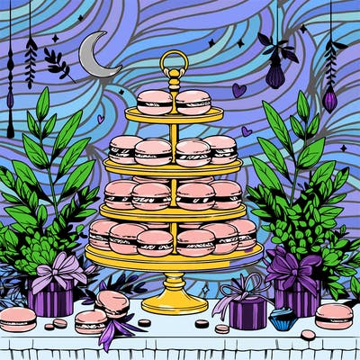 macaron display on a beautiful elegant table with eucalyptus leaves around it and small trinkets