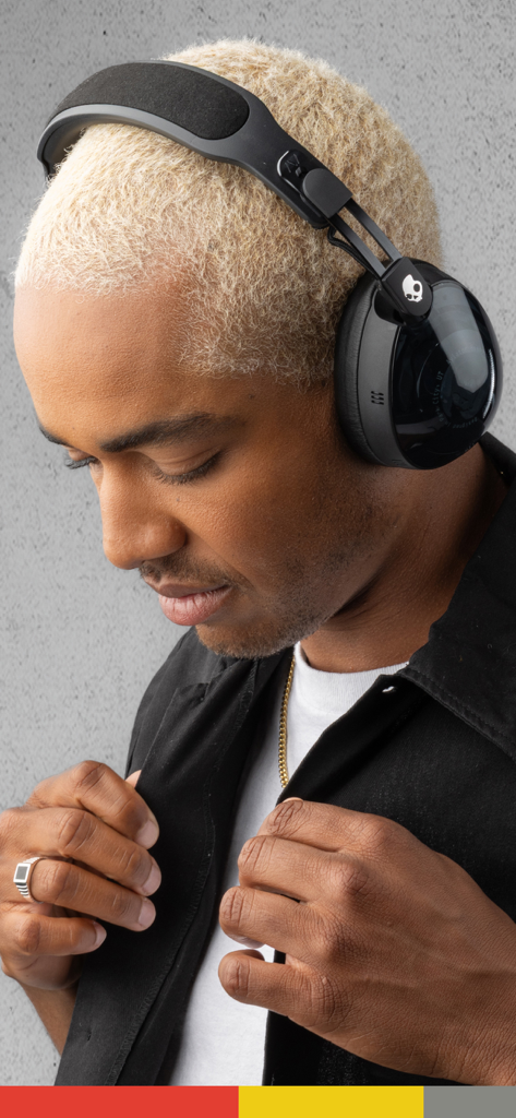 Skullcandy - Young man with blonde hair wearing black Skullcandy over-ear headphones