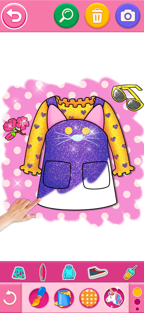 A girl using a finger to color a purple glitter kitty dress in a creative coloring app