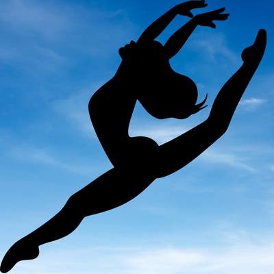 dancer doing a leap ina leotard
