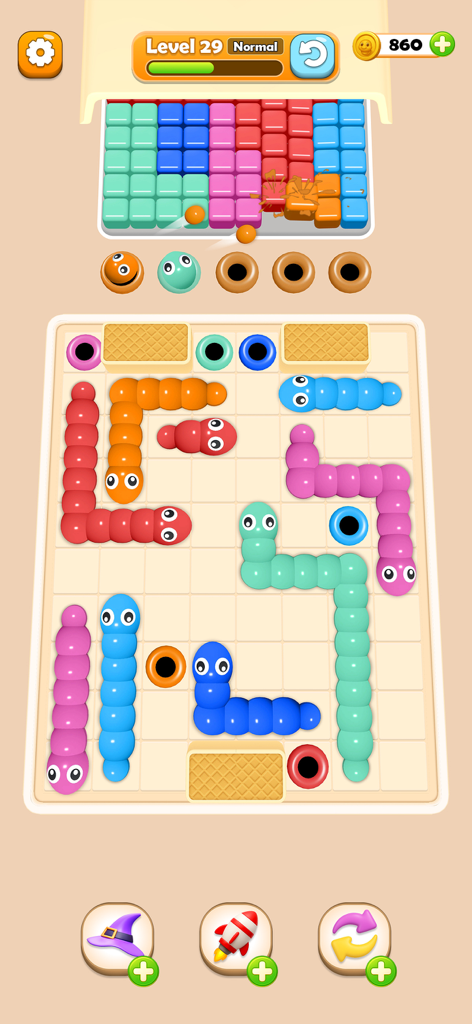 Worm Color Blast - A mobile puzzle game screen showing colorful squishy worms on a grid navigating toward matching colored holes.