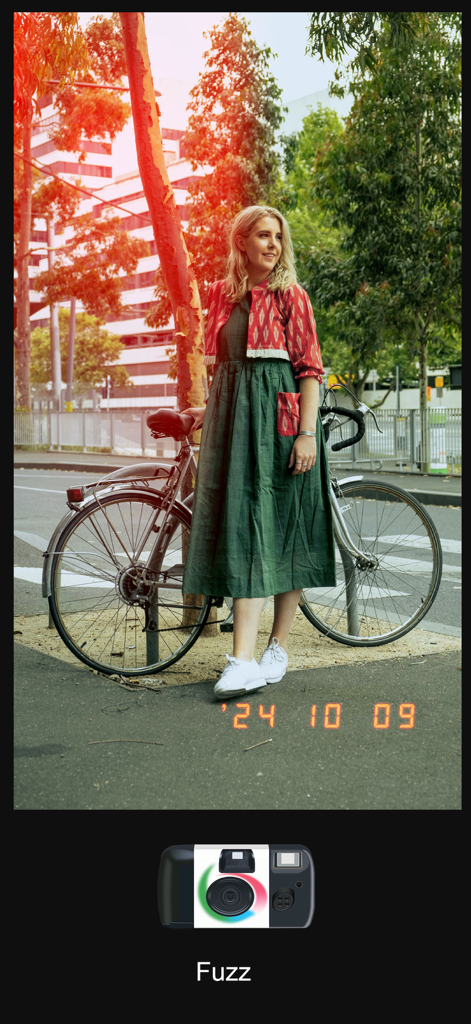 A woman standing by a bicycle with a vintage film effect including a light leak and date stamp