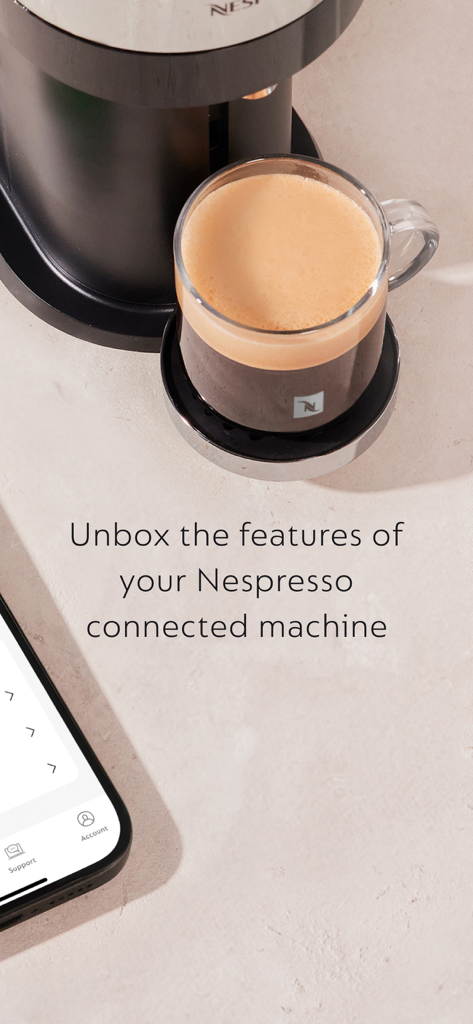 신선하게 추출된 커피와 네스프레소 머신 옆에 있는 Nespresso Smart 앱을 표시하는 스마트폰