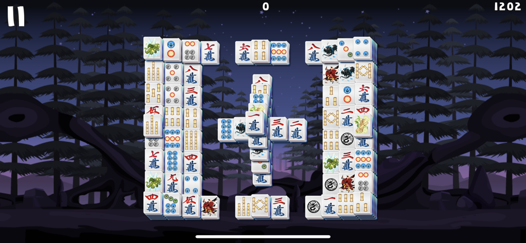 Mahjong Deluxe 3 Go - Mahjong Solitaire puzzle layout with traditional Chinese tiles set against a dark night forest background
