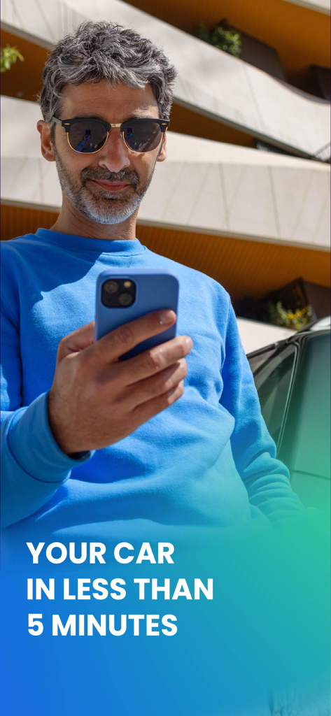 Free2move | Car Share & Rental - A man using the Free2move app on his smartphone to rent a car in a city environment