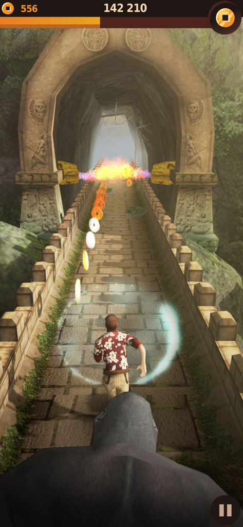 A character in a floral shirt running from a giant gorilla on a stone bridge in the Tomb Runner game.