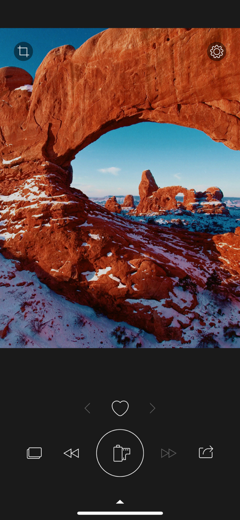 A landscape photo of a red rock arch edited with RNI Colibri film simulation