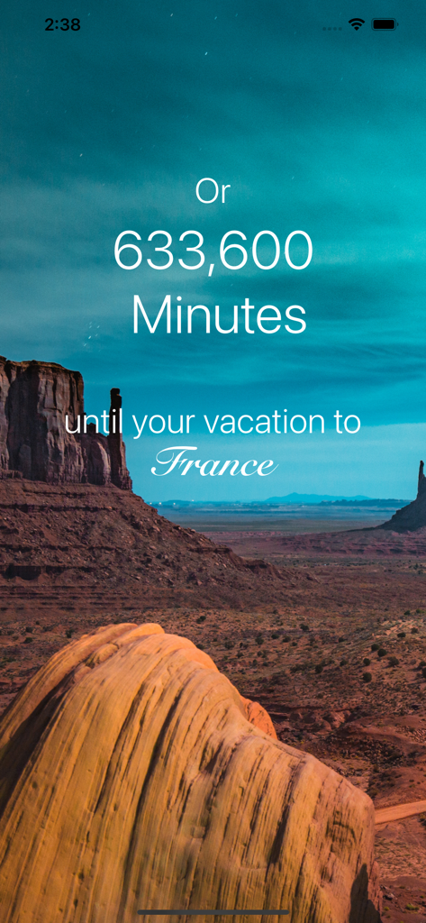 Ein Urlaubs-Countdown-Bildschirm, der die verbleibende Zeit in Minuten bis zu einer Reise nach Frankreich über einer malerischen Wüstenlandschaft anzeigt.