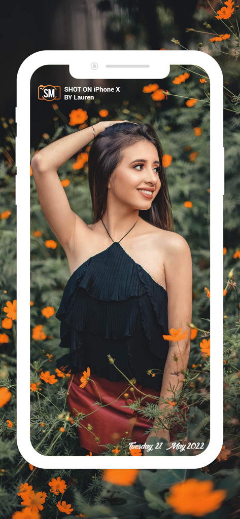 A woman posing in flowers with a Shot On iPhone X watermark and signature