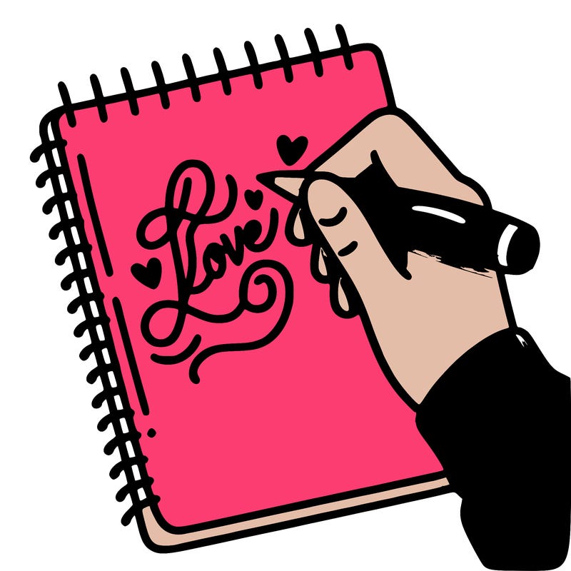 a hand writing “love” in calligraphy on a notebook