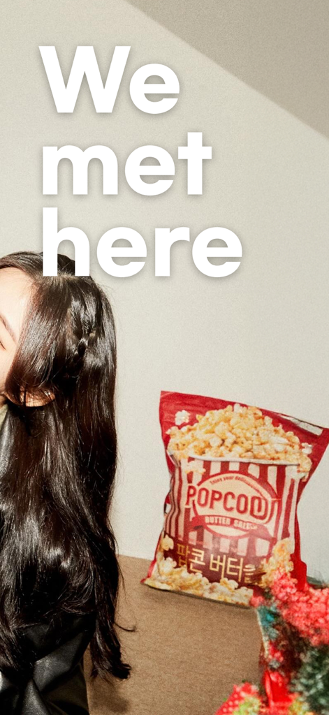 Noondate: Dating & Friends - A young woman with long dark hair next to a bag of popcorn and the text We met here