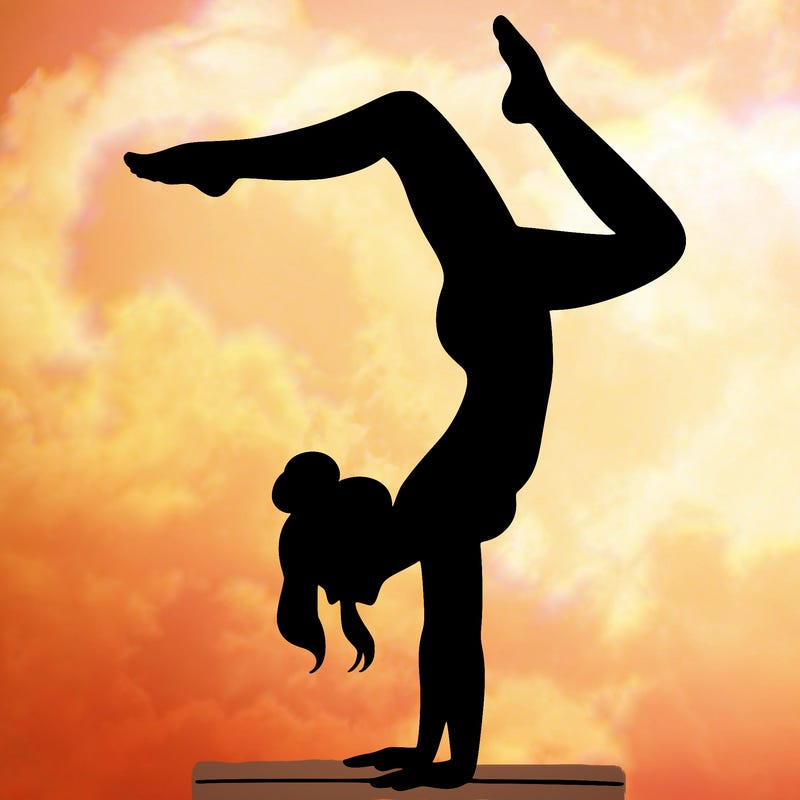 a woman doing a handstand