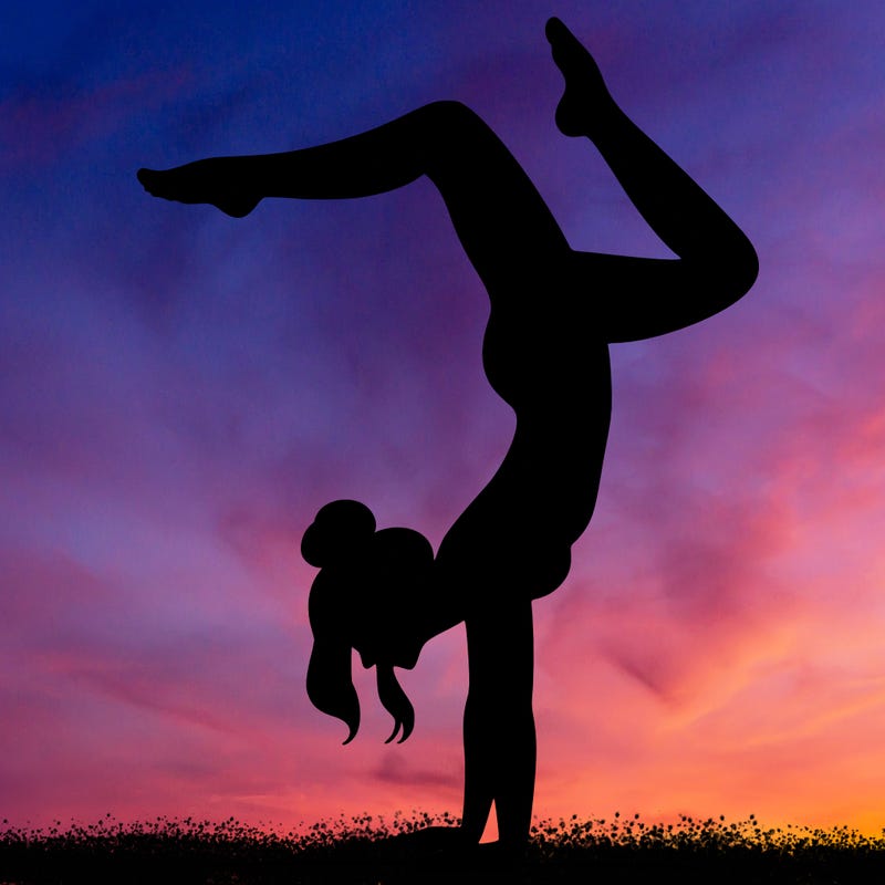 a woman doing a handstand