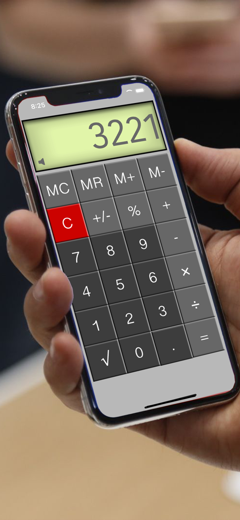 Calculator⁻ - A person holding an iPhone displaying a simple calculator app with large buttons and a pale green screen showing the number 3221.