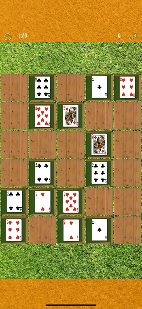 Pairs (Oh no! Another one!) - A memory matching game screen showing a grid of playing cards on a green grass background