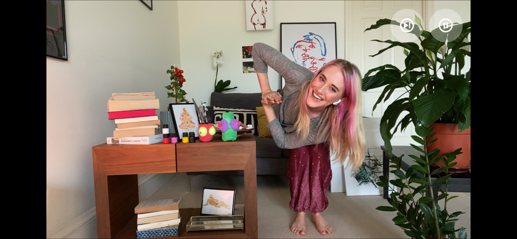 A woman with pink hair smiling during an interactive video call date in the Five Dates app