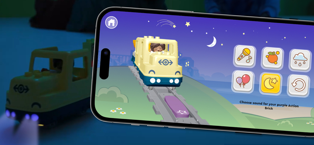 LEGO® DUPLO® Trains - A smartphone screen showing sound selection options for a LEGO DUPLO Action Brick next to a physical toy train