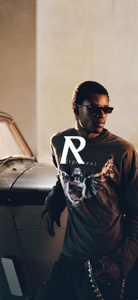 REPRESENT - Male model wearing Represent luxury streetwear graphic shirt and sunglasses