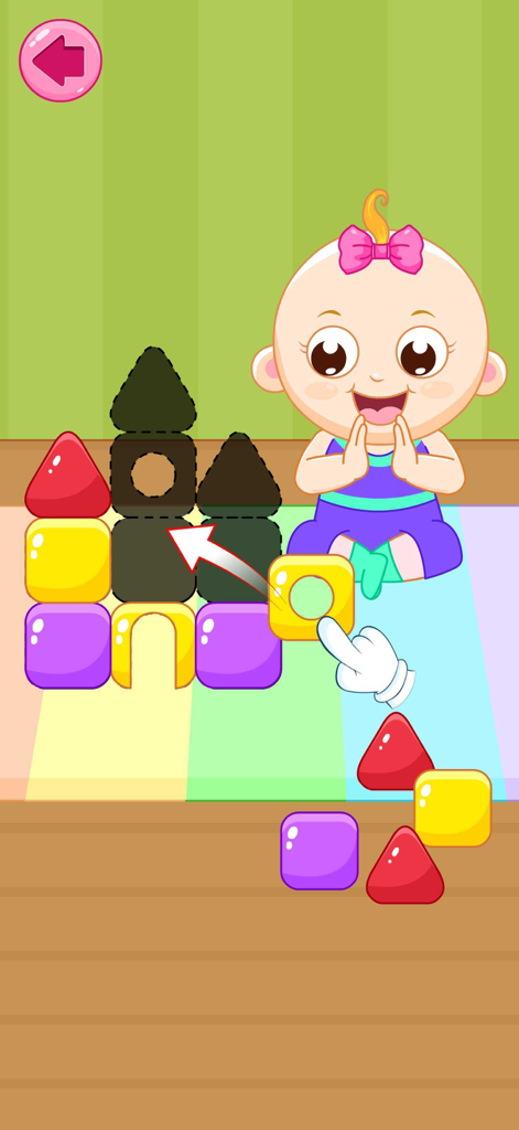 Take Care of a Baby Doll Games - A baby doll claps as a hand drags a colorful block to complete a castle puzzle.