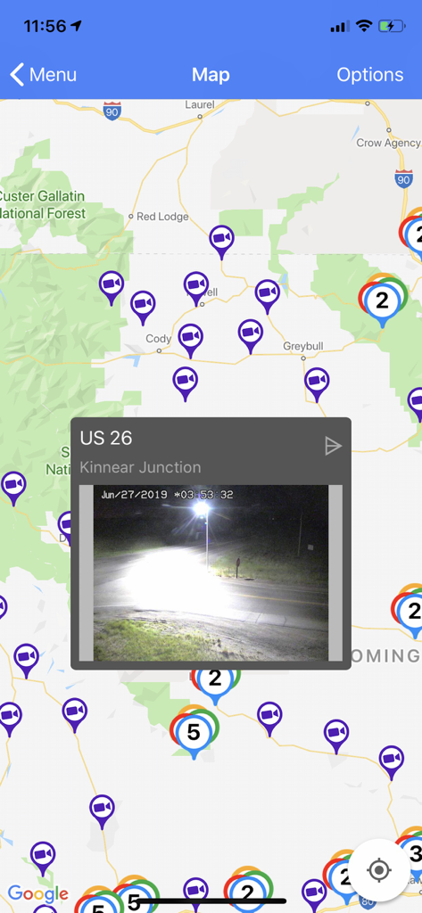 A map display from the Wyoming 511 app showing road camera icons and a live webcam preview of US 26 Kinnear Junction.