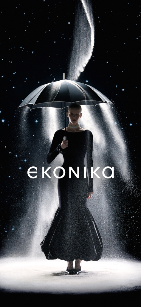 EKONIKA — обувь и аксессуары - An elegant woman in a black mermaid dress holding an umbrella under a starry sky with sand effects and the EKONIKA brand name.