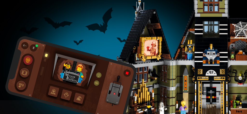 LEGO® パワード アップ アプリの Haunted House ビルディング セットのリモート コントロール インターフェイスを表示するスマートフォン画面