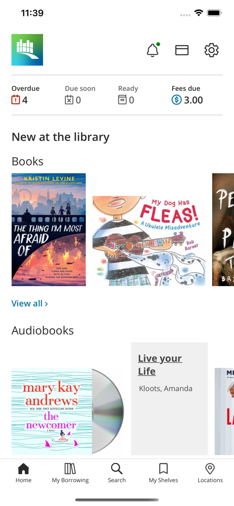Surrey Libraries app home screen showing account status for overdue items and fees alongside new book and audiobook listings