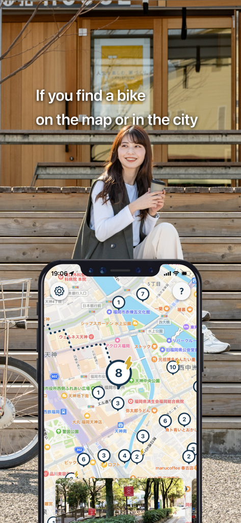 Charichari - Bike Share - Smartphone showing the Charichari app map with bike locations next to a young woman sitting outside