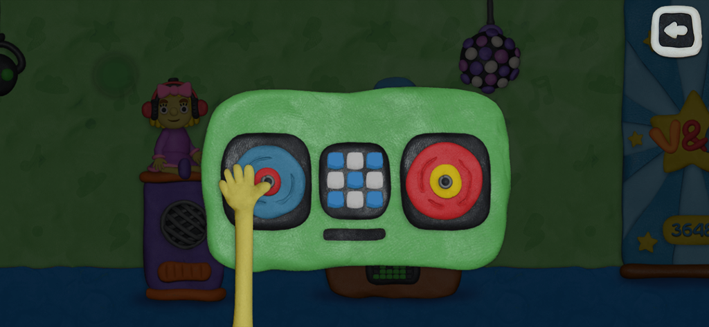 Una mano interactuando con un rompecabezas de tocadiscos DJ de plastilina en el juego de Vlad y Niki.