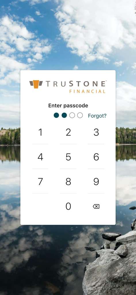 TruStone Mobile app secure login screen featuring a four digit passcode entry and numeric keypad over a scenic lake background