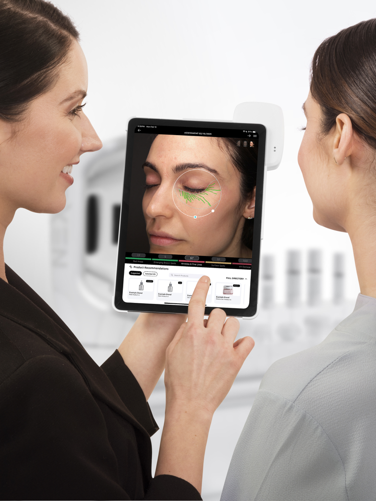 A professional esthetician using the NEXA app on an iPad to provide a personalized skin analysis for a client
