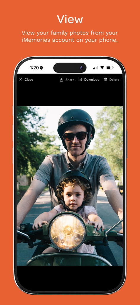 iMemories - iMemories app displaying a family photo of a man and child on a scooter on an iPhone