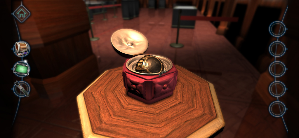 Machinika Museum - An intricate golden mechanical object inside an open red puzzle box on a wooden pedestal