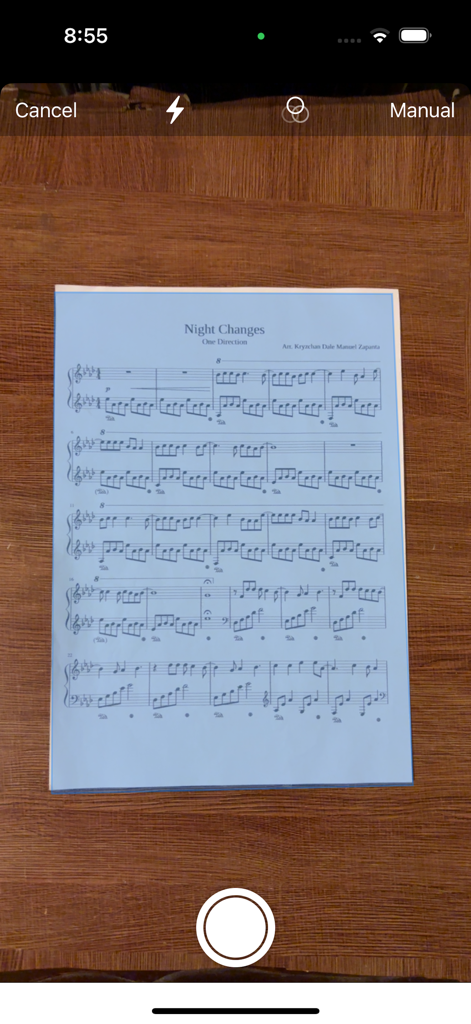 ScanScore Scanner - Smartphone camera interface capturing a physical sheet music page for digital conversion