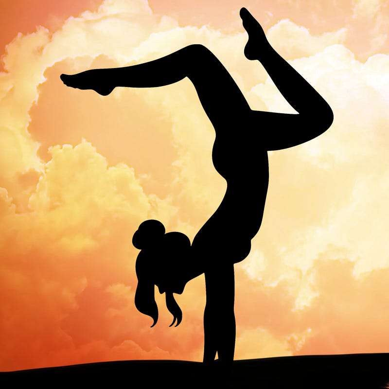 a woman doing a handstand