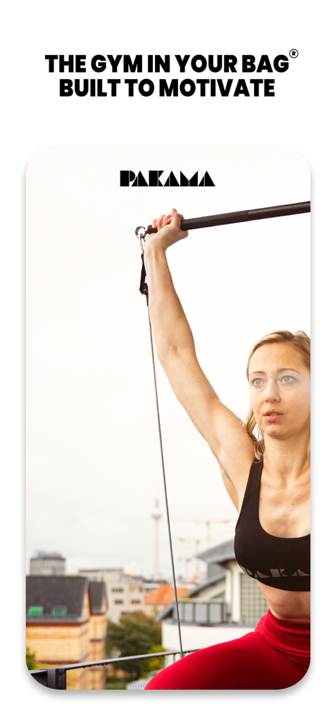 A woman performing a resistance band workout on a city rooftop with PAKAMA equipment