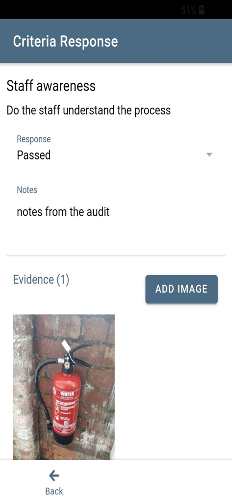 MY Audits - A criteria response screen in the MY Audits app showing a passed staff awareness check with a photo of a fire extinguisher as evidence