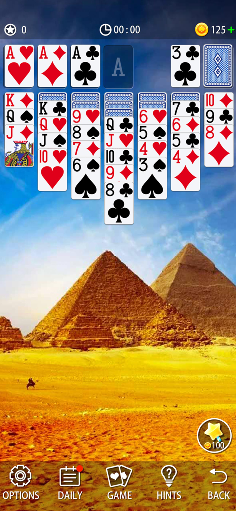 Classic solitaire card game interface with an Egyptian pyramid landscape background