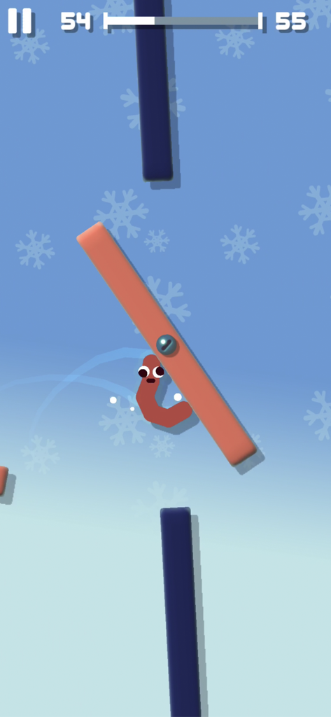 Sausage Flip - ソーセージフリップの雪景色をテーマにした冬のレベルで、回転するプラットフォームにしがみつく目のついたソーセージキャラクター。