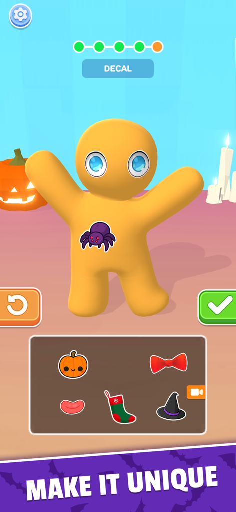A yellow 3D character being decorated with a spider decal in the Toy Master game interface