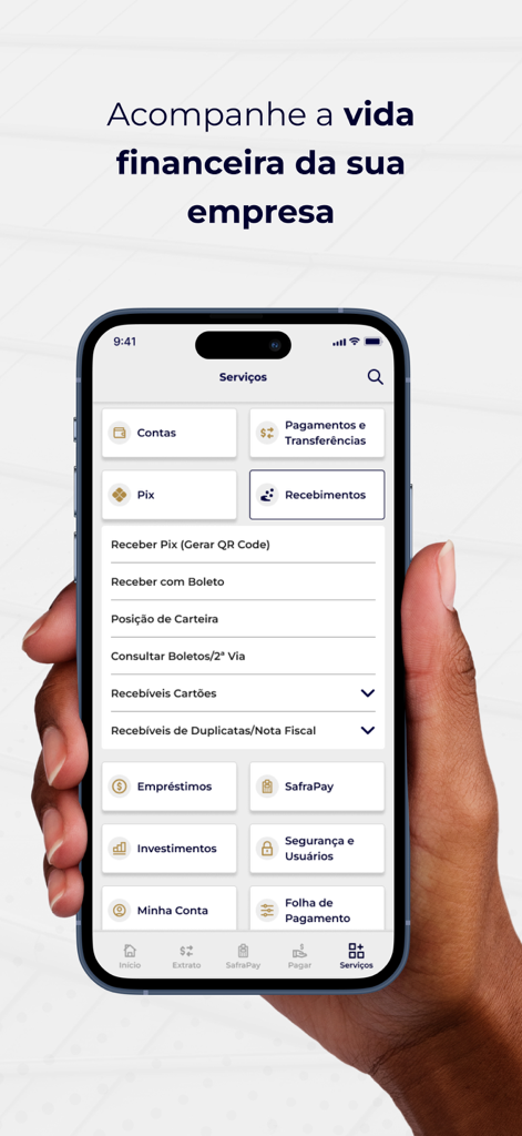 Safra Empresas: A sua conta PJ - Uma mão segurando um smartphone exibindo o menu de serviços do app Safra Empresas com várias opções de banking para empresas
