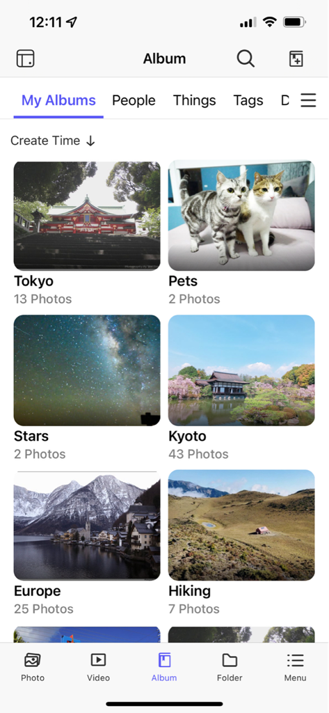 The QuMagie mobile app interface displaying a grid of categorized photo albums including Tokyo Pets Stars and Kyoto