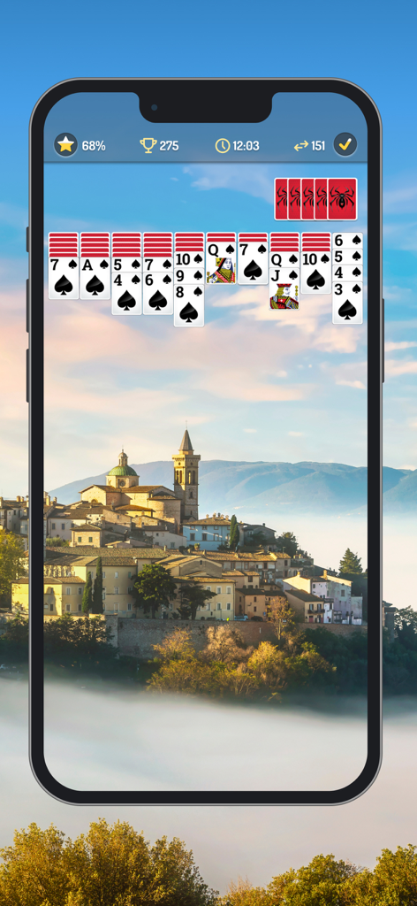 Interfaz de juego de Spider Solitaire con fuentes grandes y un fondo personalizable de un pueblo escénico.