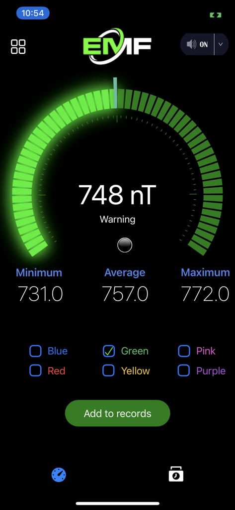 EMF detector app interface displaying a magnetic field reading of 748 nanoTesla with a circular green gauge and statistics