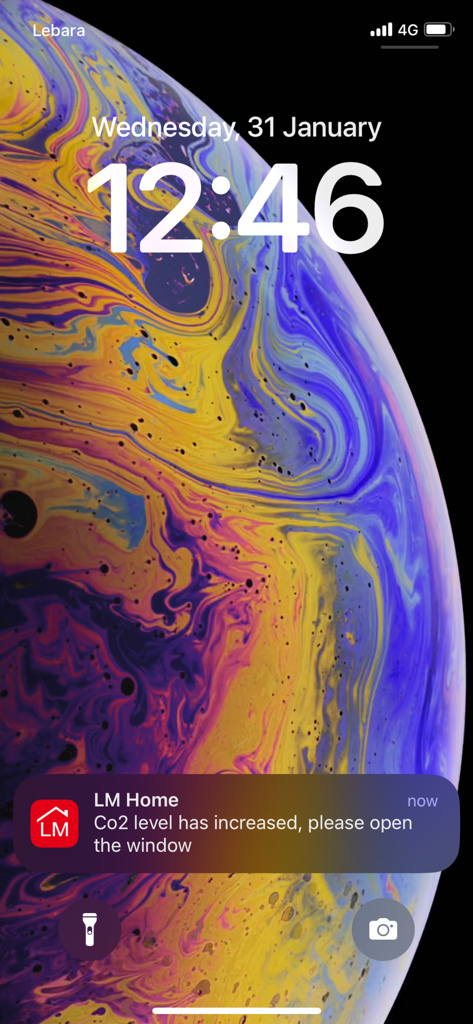 LM Home - iPhone lock screen showing a push notification from the LM Home app regarding high Co2 levels