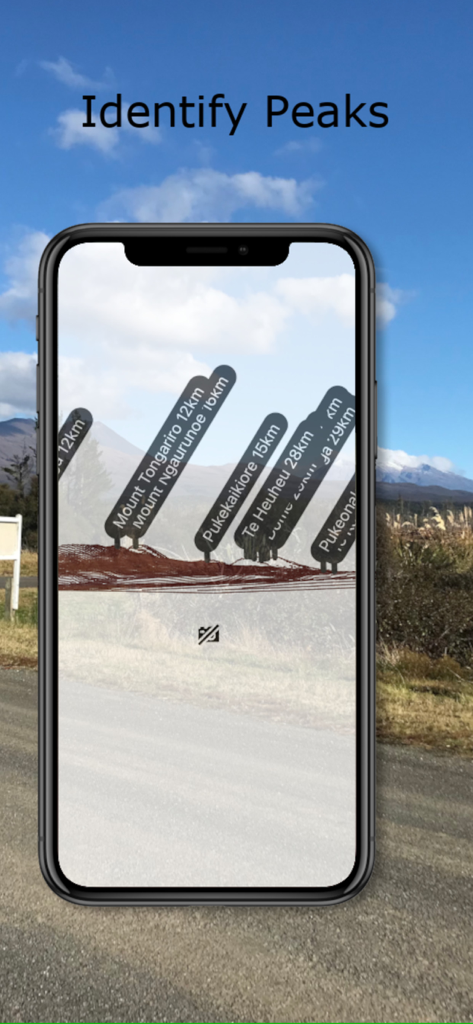 A smartphone showing an augmented reality view that labels mountain peaks and their distances in the NZ Topo50 app.