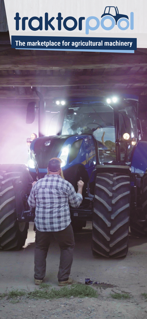 tractorpool - Un agricultor celebrando frente a un gran tractor azul moderno dentro de un granero