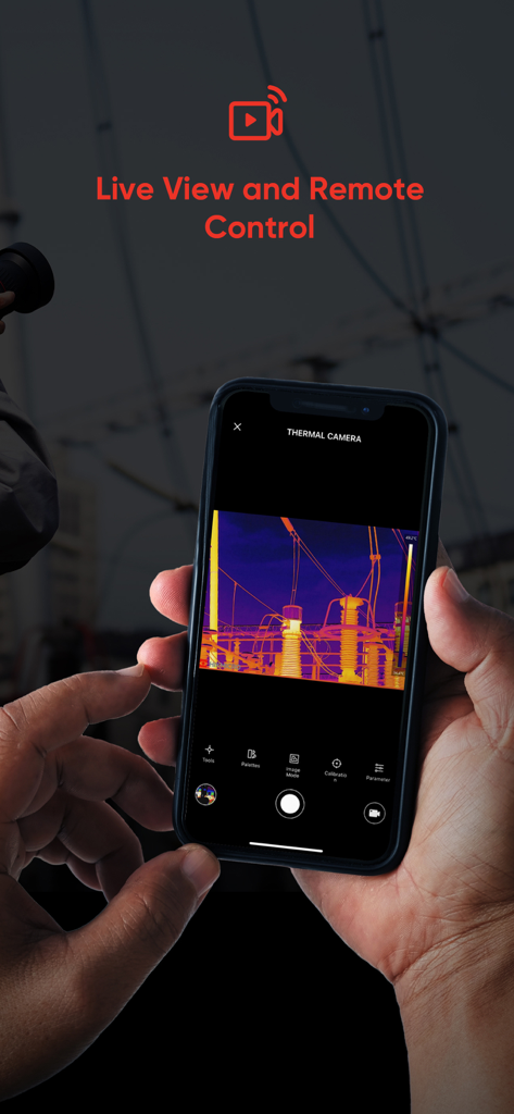 A person holding a smartphone showing a live thermal imaging feed of an electrical substation using the HIKMICRO Viewer app