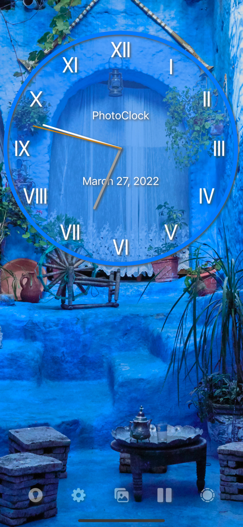 PhotoClock Pro - A customizable analog clock with Roman numerals displayed over a serene blue courtyard photograph background