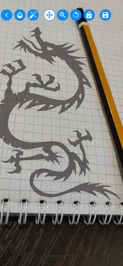 Tracing projector & Lightbox - A dragon silhouette projected onto a notebook for tracing with a mobile app